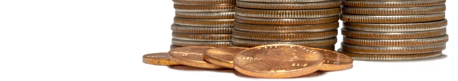 Stack of quarters, dimes, and pennies illustrating seignorage.