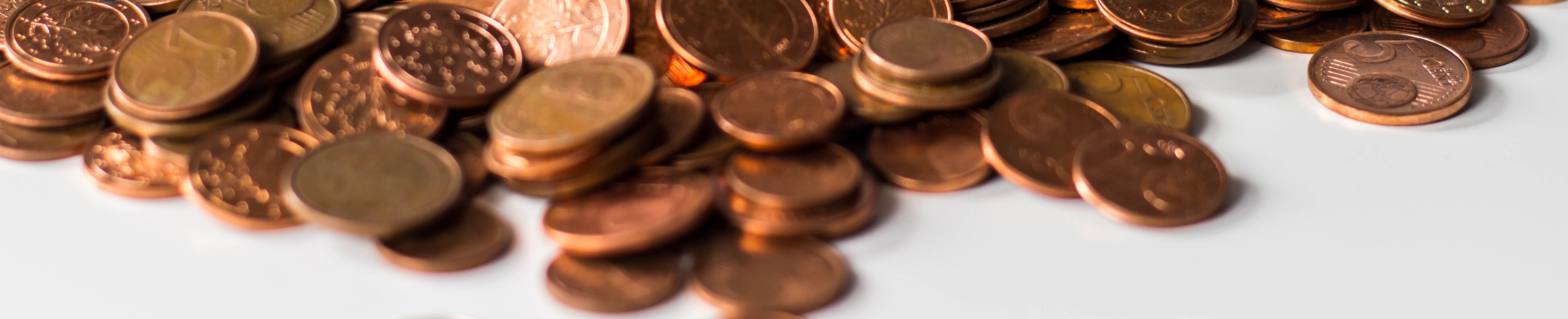 Pennies and copper coins in a pile.