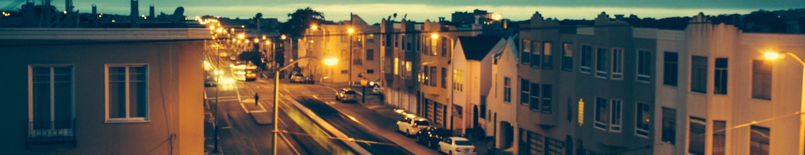 Houses on a busy street with lots of noise.