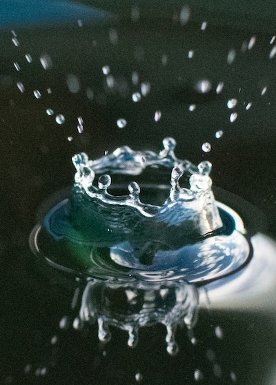 Drop of water in a lake with tiny droplets.