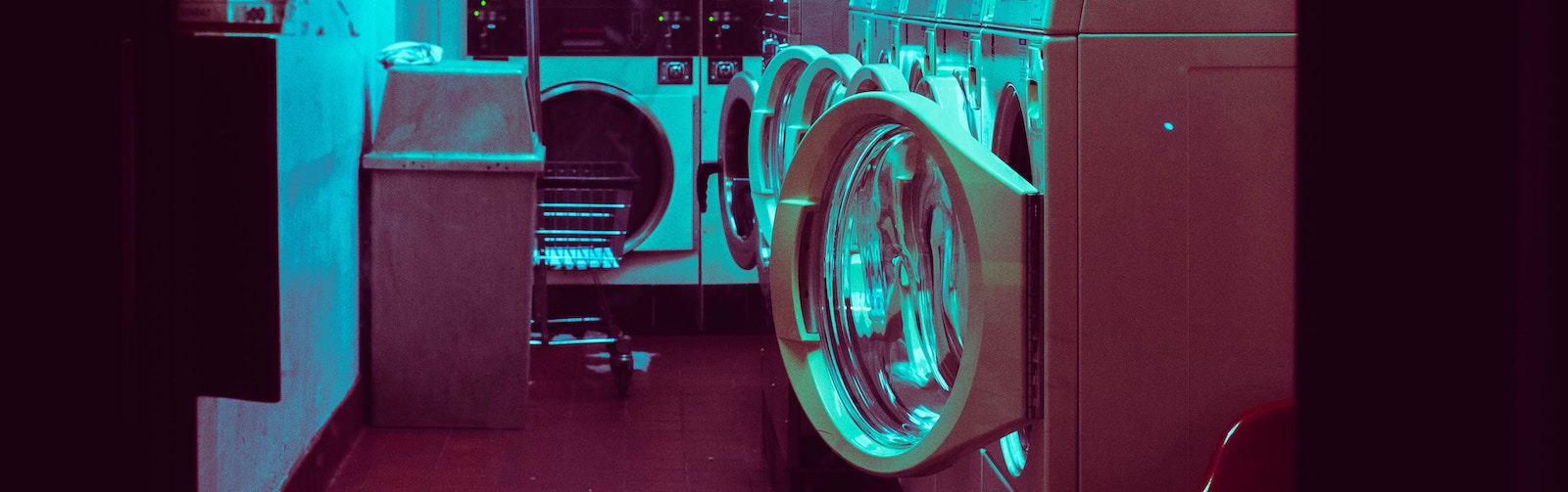 Picture of washing machines open in a laundromat.