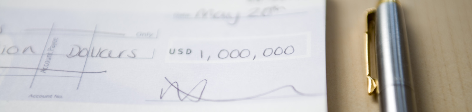 A check for a million dollars next to a nice pen