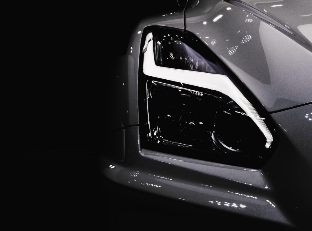 Black and white image showing a car headlight